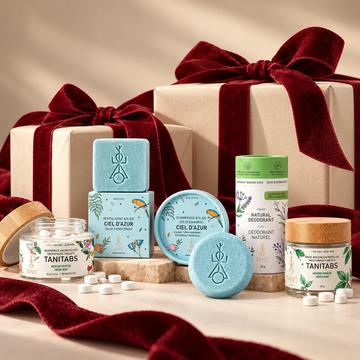 TANIT solid routine essentials styled with cream wrapped gifts and burgundy bows